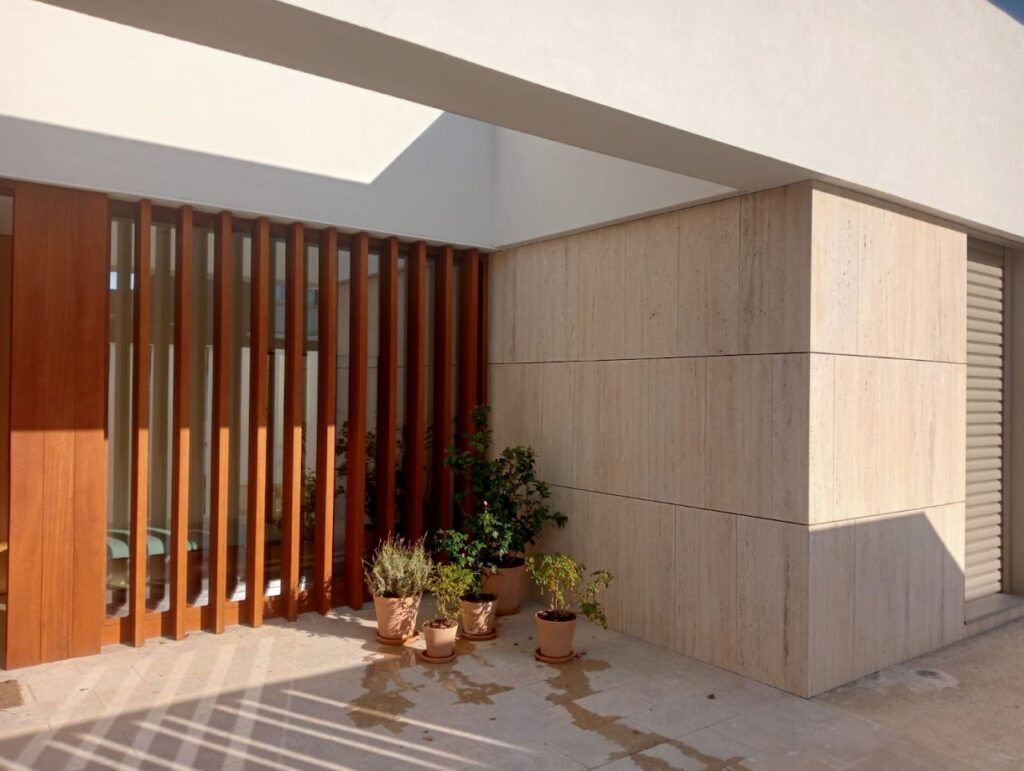 Fachada de travertino y lamas de madera en Zaragoza